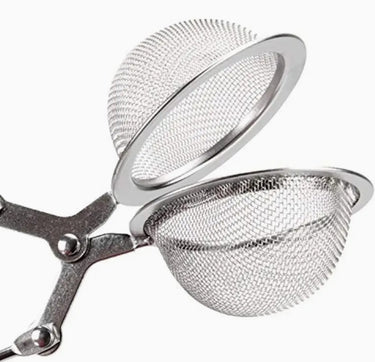 Metal mesh tea infuser on a white background
